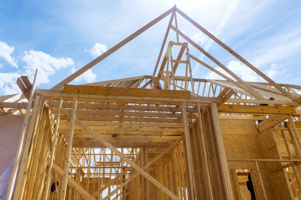 istock Framing of beams stick built house on new home under construction 1402767281
