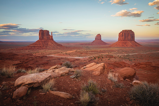 Landscape image overlooking the famous scene of West Mitten, East Mitten, and Merrick Butte in Monument Valley, Arizona, USA.