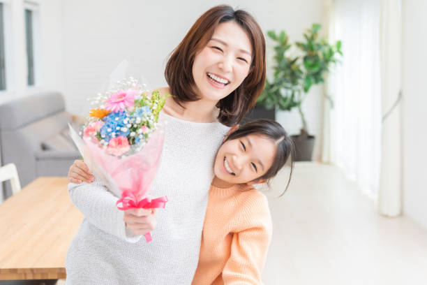 asian mother and daughter,bouquet young asian mother and daughter,bouquet child japanese culture japan asian ethnicity stock pictures, royalty-free photos & images