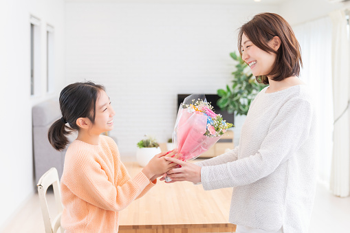 young asian mother and daughter,bouquet