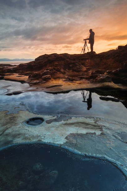 istock Photographer Along The Rugged Coastline 1402770995