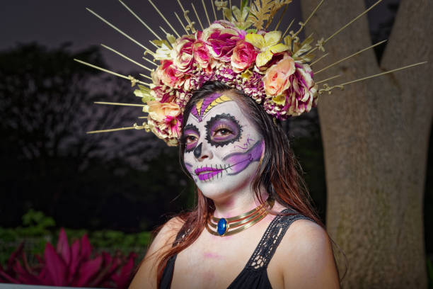 istock Young woman with sugar skull makeup. 1402771120