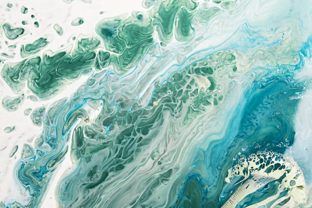istock Fluid Art acrylic paints. Abstract mixing blue and green waves on white background. Liquid flows splashes. Marble effect background or texture 1402773179