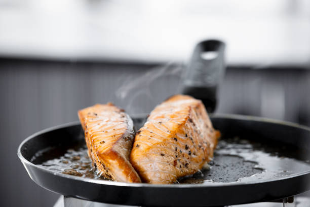istock Salmon filet in frying pan 1402773362