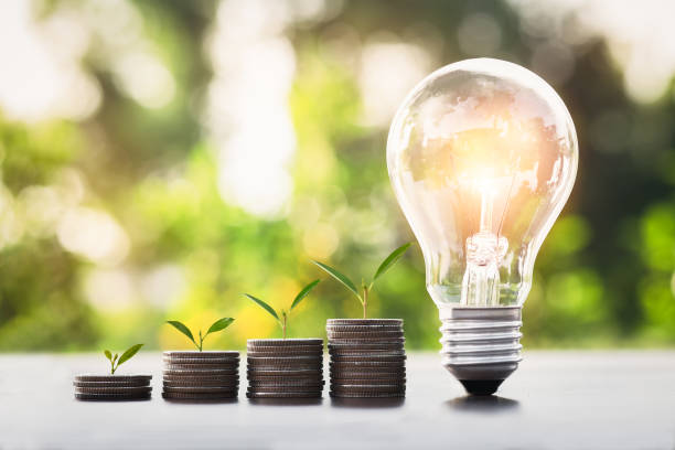 istock a light bulb with coins stack and trees are growing , savings and investment concepts. 1402774998