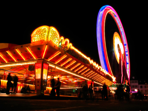 Cheerful couple having fun during amusement park ride in blurred motion.