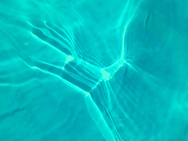 istock Defocus blurred transparent blue colored clear calm water surface texture with splashes and bubbles. Trendy abstract nature background. Water waves in sunlight. Blue water background. 1402776752