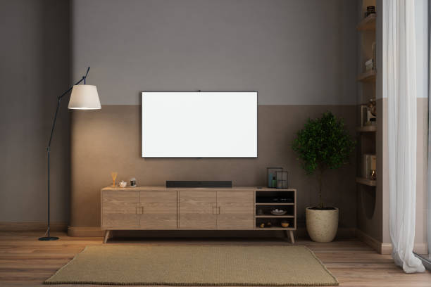 salon moderne la nuit avec maquette de télévision, armoire, plante en pot et lampadaire - tv wall unit photos et images de collection