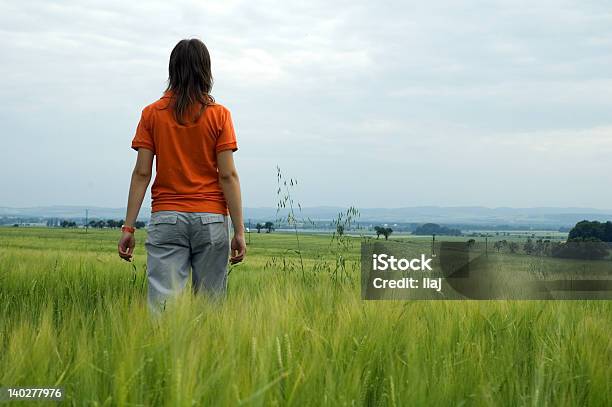 Chica Caminando En Campo Con Vista Al Valle Foto de stock y más banco de imágenes de Adolescente - Adolescente, Adulto, Agricultura