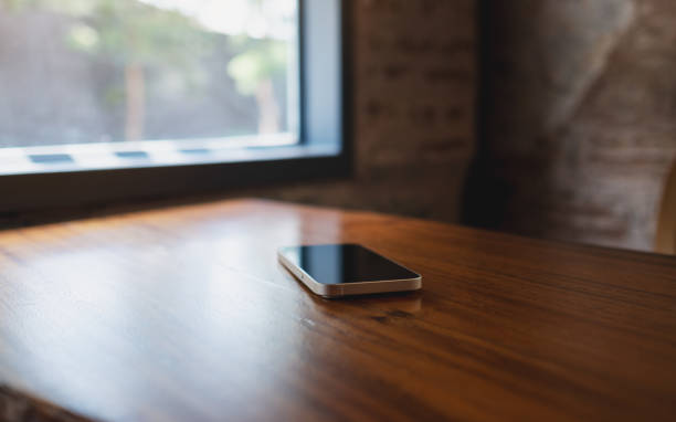 istock A single mobile phone on wooden table 1402779857
