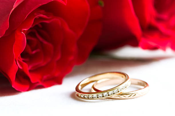 istock wedding rings and red roses 140278404