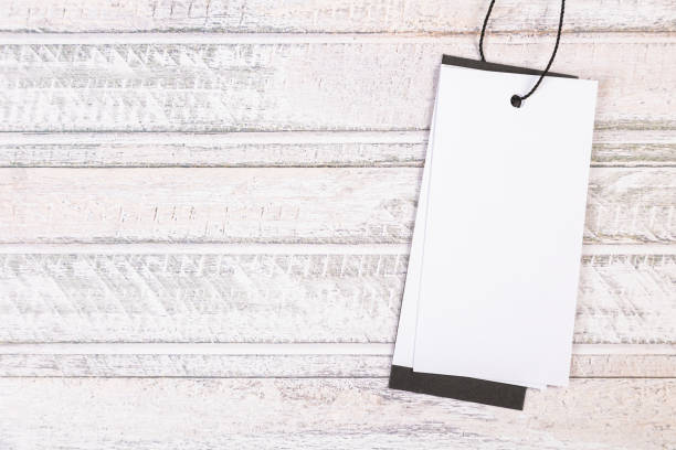 istock white Blank tag on a light wooden background 1402785691