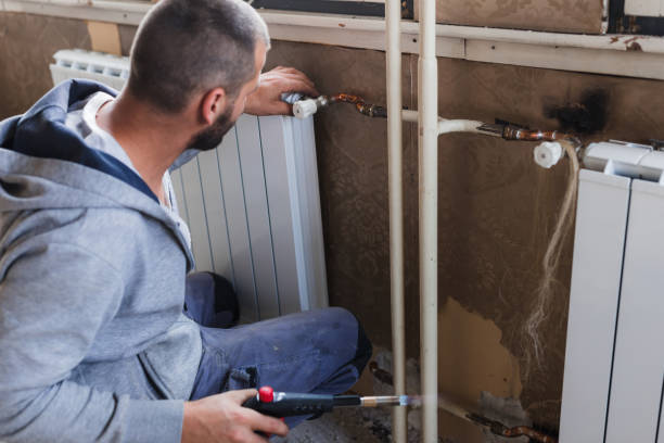 istock Plumber welding radiator at home with a blowtorch 1402788054