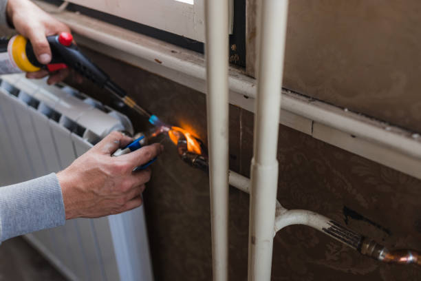 istock Plumber welding radiator at home with a blowtorch 1402788072