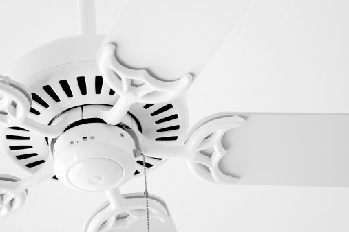 A white ceiling fan against a white ceiling. Subtle contrast.