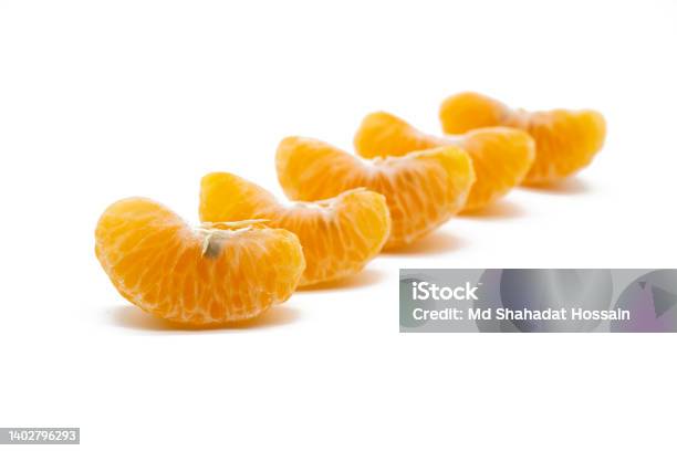 Some Slices Of Tangerine Isolated On White Background Stock Photo - Download Image Now