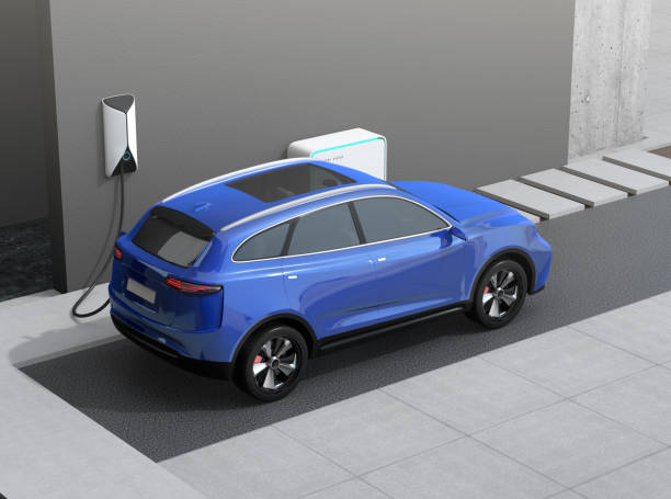 Rear view of blue electric SUV charing at home garage stock photo