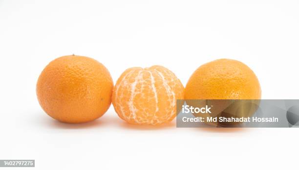 Whole And Slice Tangerine Or Kamala Over On White Background Stock Photo - Download Image Now