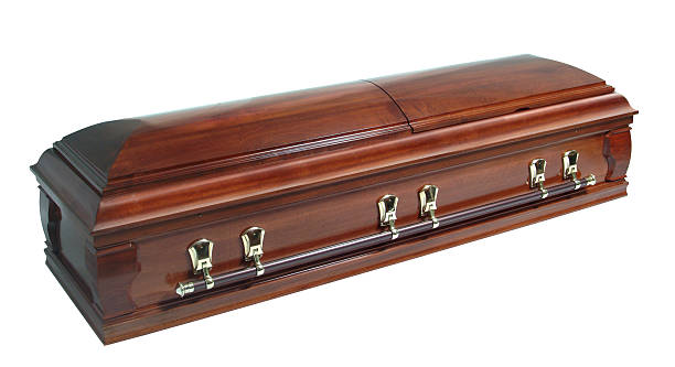 A beautifully polished wooden casket with deep timber tone  brown casket isolated on white coffin photos stock pictures, royalty-free photos & images