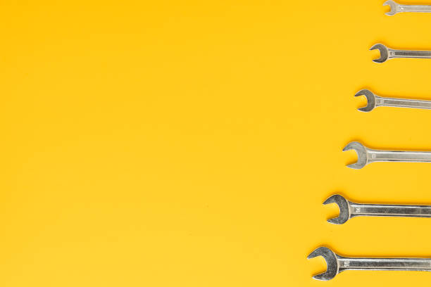 istock Handyman's tools. set of wrenches of different sizes on yellow background. Flat lay. Happy Father's Day. Free space  for you text 1402798573
