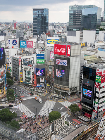Shibuya, Tokyo, Japan - 28 May 2022: Aerial view of the famous Shibuya crossing at Tokyo downtown with a crowd of people.