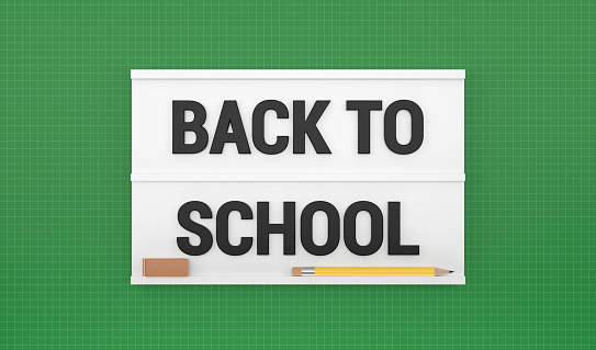 Back to School text and pencils on the lightbox is on a green background. Back to school concept.