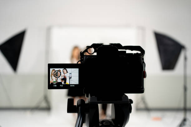 istock Video broadcast camera taking live video live streaming conference at people talking with selective focus camera 1402800779