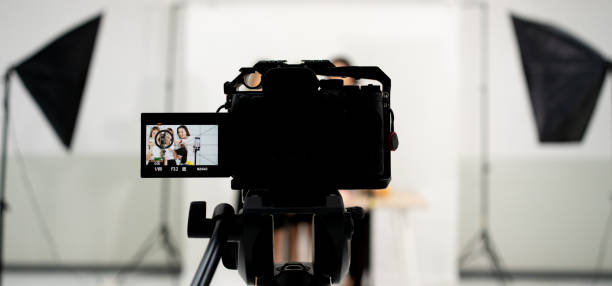 istock Video broadcast camera taking live video live streaming conference at people talking with selective focus camera 1402800780