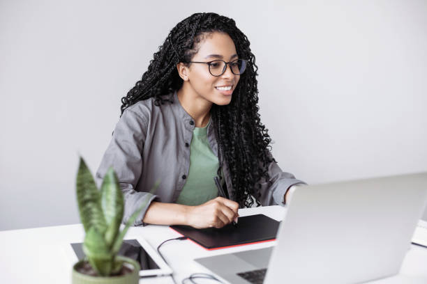 istock Woman working from home, having meeting online. Designer using graphics tablet in office 1402801696