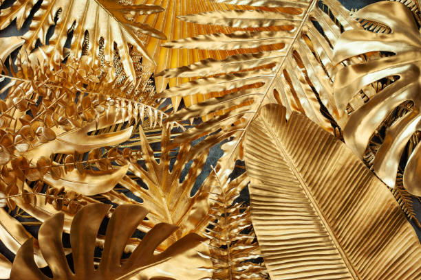 istock Gold tropical monstera and palm leaves 1402801943