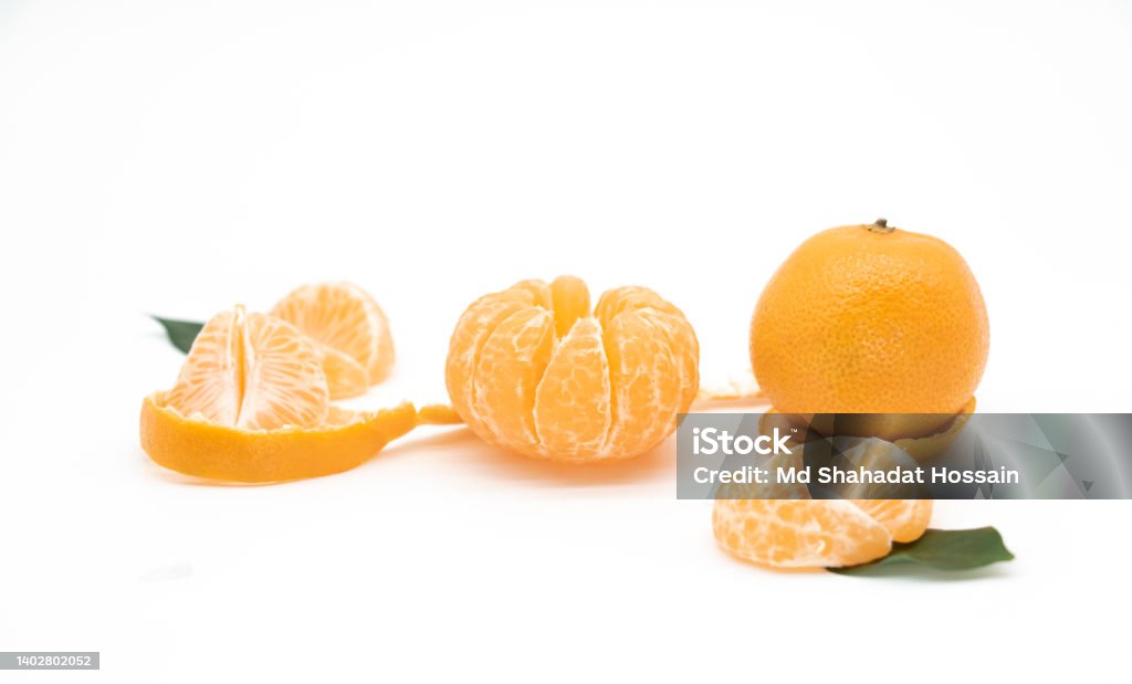 Tangerine or kamala pieces with green leaf isolated on white background Bangladesh Stock Photo