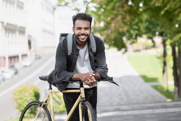 istock Handsome young man with bicycle in a city 1402803198