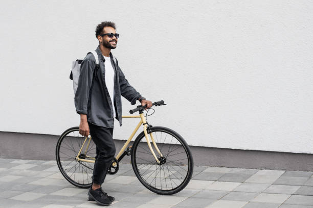 istock Handsome young man with bicycle in a city 1402803220