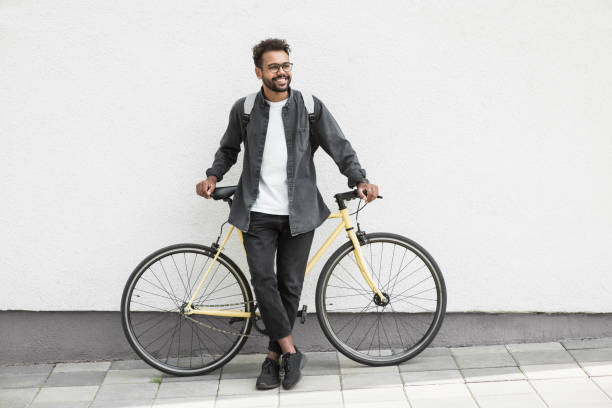 istock Handsome young man with bicycle in a city 1402803231