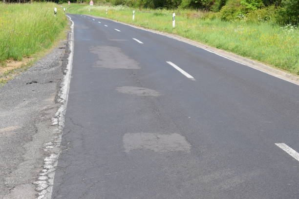 istock bad repairs in a country road 1402804527