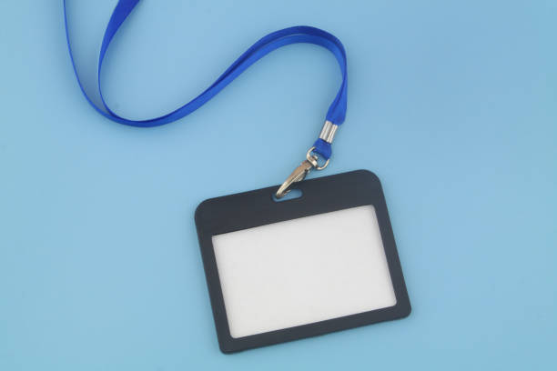 Black badge with blue ribbon on blue background stock photo
