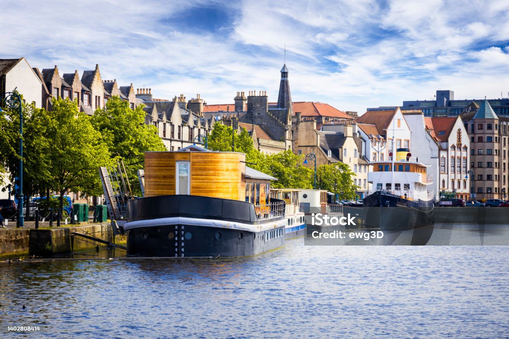 Holidays in Scotland - Scenic Leith Harbour on the north east side of Scotland's capital city of Edinburgh A scenic view of Edinburgh's popular Leith Harbour, with moored boats and historic dock buildings now converted for residential and commercial use Edinburgh - Scotland Stock Photo