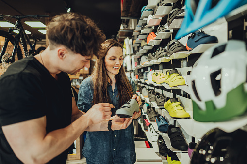 woman buying a cycling shoes in bike shop