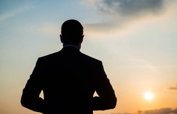 istock silhouette of man looking far on sunrise sky, future 1402811467