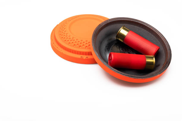 Red shotgun shell and clay pigeon target on white background , Gun shooting game Red shotgun shell and clay pigeon target on white background , Gun shooting game trap shooting stock pictures, royalty-free photos & images