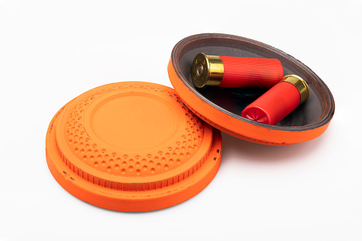 Red shotgun shell and clay pigeon target on white background , Gun shooting game