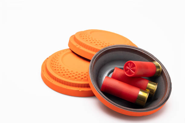istock Red shotgun shell and clay pigeon target on white background , Gun shooting game 1402811529