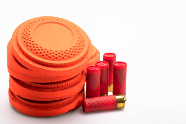 istock Red shotgun shell and clay pigeon target on white background , Gun shooting game 1402811535