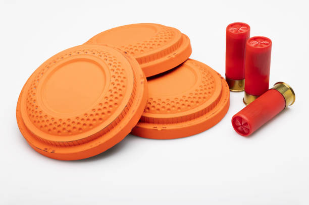 istock Red shotgun shell and clay pigeon target on white background , Gun shooting game 1402811536