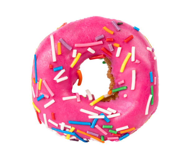 istock pink donut with colorful sprinkles isolated on white background 1402813307