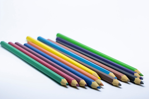 Close-up photo of colored crayons taken in a light box with a white background.  The best friend of children who love to draw.