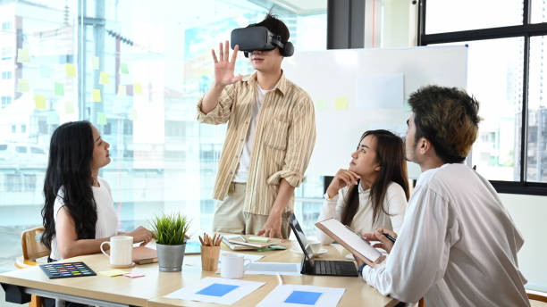 istock Team of professional developers is brainstorming for augmented reality improvement, future technology for business. Concept of people and augmented reality. 1402814160
