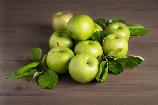 Green apples in wooden case