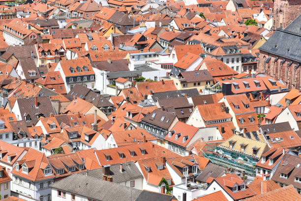 Urban Landscape with Red-Tiled Roofs and Construction Crane