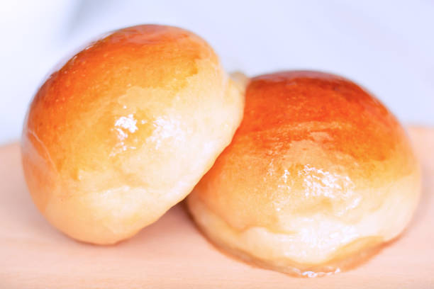 istock Close up two butter bread bun  on wooden plate 1402815614
